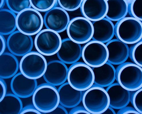Blue pipes stacked together.