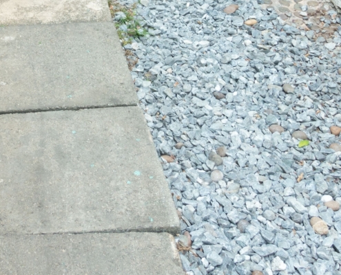 french-drain A french drain next to a row of paving stones.